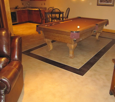Basement concrete floors with a billiards table in Lansing, Michigan.