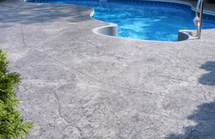 Pool deck in Lansing, Michigan with a stamped concrete design.