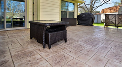 Stamped concrete patio with patio furniture in Lansing, Michigan.