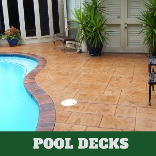 Pool deck with a stamped and stained concrete finish from Lansing stamped concrete contractor. 