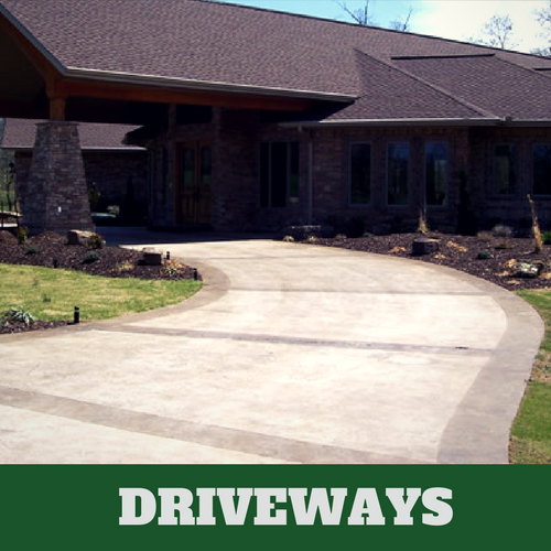 Two toned colored concrete driveway in Lansing, Michigan with brick home.