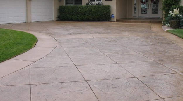 Stained concrete driveway with a reddish brown color in Mason, Michigan.
